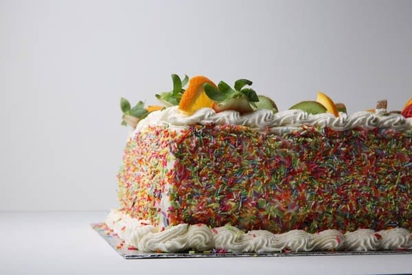 Fruit decorated cake with hundreds and thousands from Quigleys cafe, bakery and deli