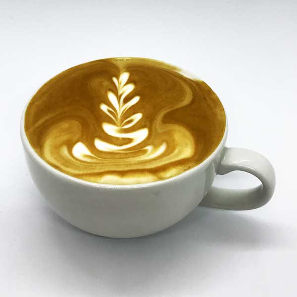 A flat white from Quigleys cafe, bakery and deli with coffee art