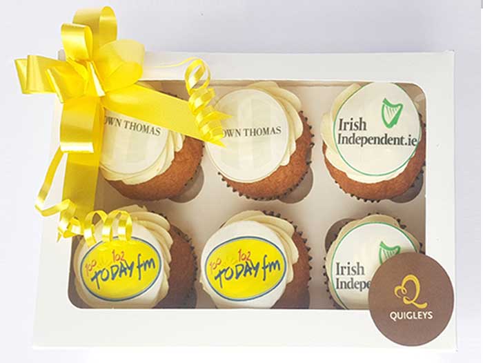 Six themed cupcakes by Quigleys bakery with Brown Thomas, Irish Independent and Today FM logos